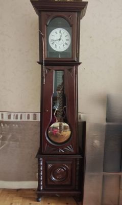 a grandfather clock that is in the corner of a room