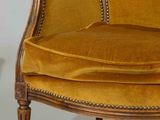 a yellow chair that is sitting next to a table