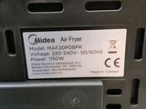 a close up of a metal air fryer with a label on it