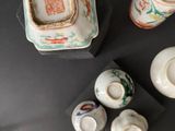 three cups and a saucer sitting on a table