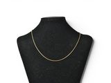 a black mannequin with a gold chain on it