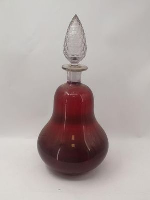 an image of a red glass perfume bottle with a clear top