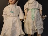 two dolls that are standing next to each other