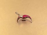 a small bird charm that is sitting on a table