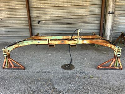 an image of a rusted metal bench in front of a garage