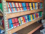 many books that are on the shelves in the room