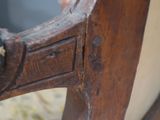 a bird that is sitting on the back of a chair