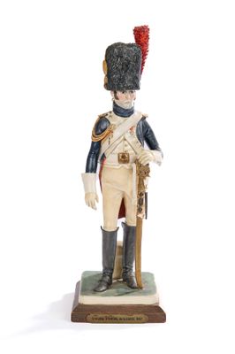 figurine of a toy soldier with a red hat and uniform