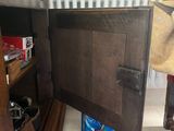 a wooden cabinet with a door open in a room