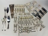 a lot of silverware on a table with a fork and knife