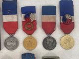 some of the medals and medals have been placed on a white surface