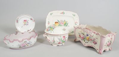 three pieces of porcelain on display on a table