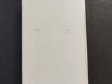 the back of a white box sitting on top of a black table