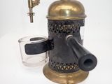a coffee grinder and a glass on a table