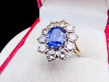 an image of a blue sapphire and diamond ring in a white box