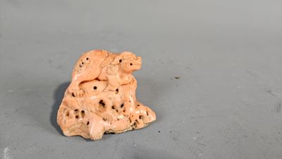 a small figurine of two bears sitting on a table