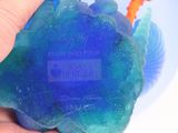 a person holding a soap ball in their hand