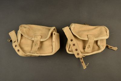 pair of old leather baseball mitts on a gray surface