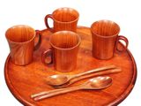 a wooden tray with cups and spoons on it