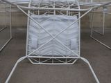 a white chair that has a white cushion on top of it