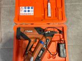 an orange tool box with a stapler and a nail gun in it