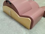 a pink couch that is sitting in a warehouse