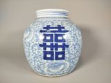 a blue and white vase with a double happiness symbol on it