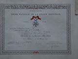 a certificate on the wall of a building with a red ribbon