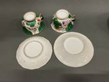 three cups and saucers sitting on a table