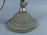 a statue of a person on a table with a lamp