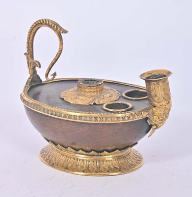 a gold and black vase with a bird on it