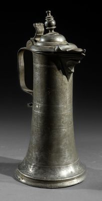 an old pewware with a handle and a handle on it