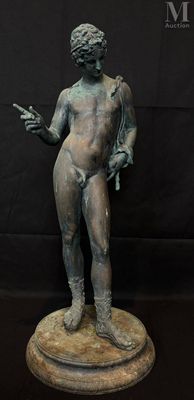 bronze statue of a man holding a knife on a pedestal