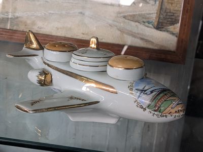 a small model of a plane sitting on a glass table