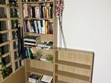 a tall book shelf with a bunch of books on it