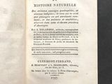 an open book on a table with a black background