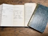 two open books sitting on a wooden table