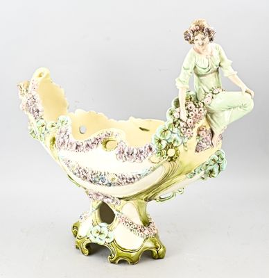 porcelain figurine of a woman sitting on top of a bowl