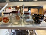 three jars sitting on a shelf in a store