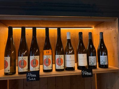 Des bouteilles de vin sont alignées sur une étagère dans un magasin de vins.