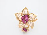 a close up of a gold ring with pink stones