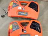 a couple of orange blowers sitting on top of a cement floor
