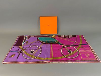 an orange box sitting on top of a table next to a purple and pink table cloth