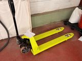 a yellow pallet sitting on the floor in a garage