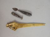 a knife, spoon, and spoon rest on a table