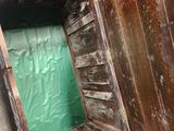 a wooden box with a green door inside of it