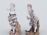 pair of figurines of a man and a woman on a rock