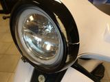 a close up of a motorcycle headlight on a motorcycle