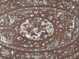 a brown table with a floral design on it