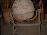 a cement mixer sitting on a cart in a building